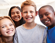 Four children smiling at the camera