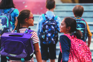 Children on their way to school with backpacks on