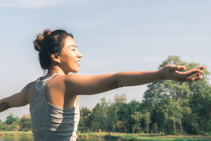 Women in field performing yoga