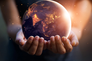 Young person holding out a earthly sphere