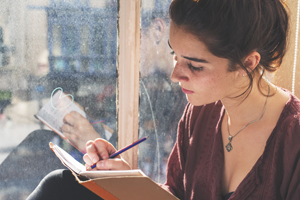 Woman writing in her journal