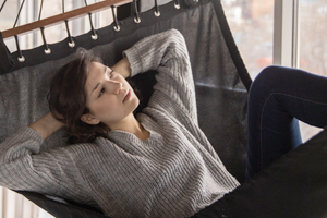 Young girl laying on a hammock deep in thought