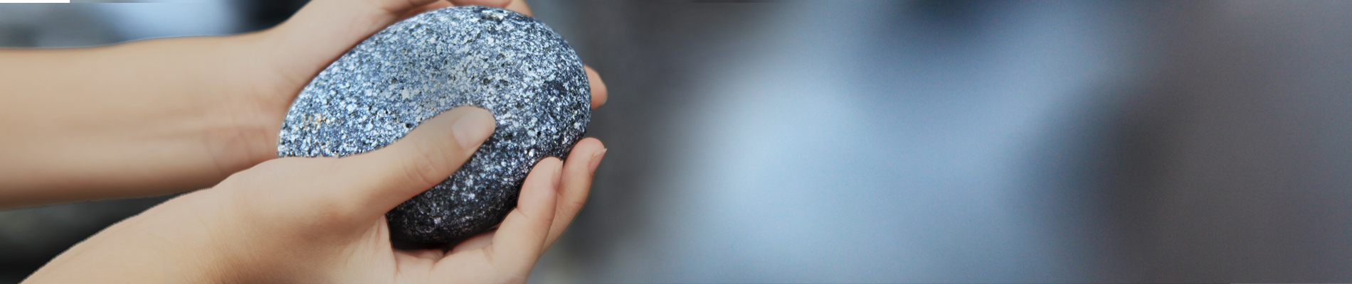 Pair of hands holding a stone