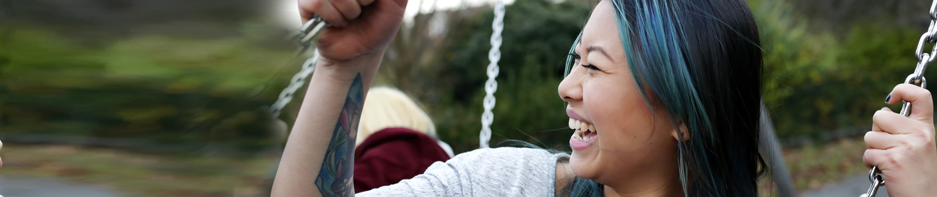 Young woman on a swing laughing