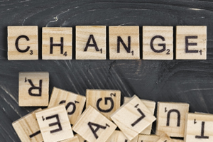 Wooden game tiles spelling out Change