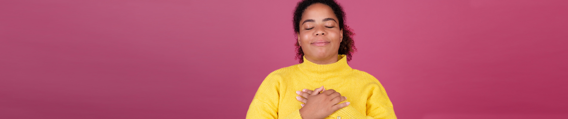 Woman with crossed arms smiling with eyes closed