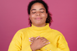 Woman with crossed arms smiling with eyes closed