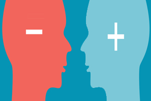 Silhouette of opposing heads with plus and minus symbols