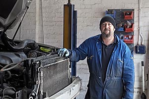A man with stalking cap in a workshop