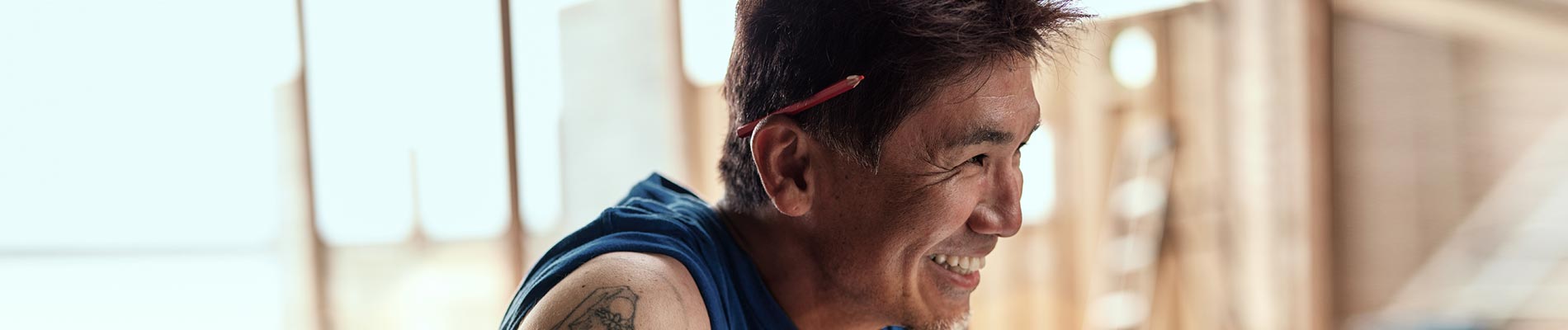 Man grinning looking onto a room being remodeled