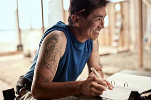 Man grinning looking onto a room being remodeled