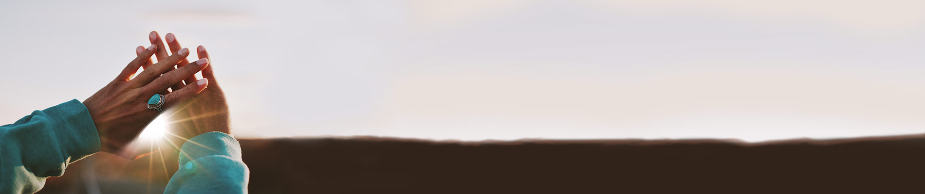 Woman hands up crossed blocking the sun