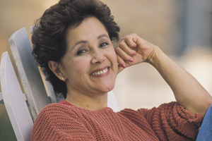 Woman sitting in a lawn chair grinning