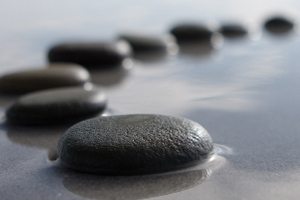 Wet stones laying on the sand