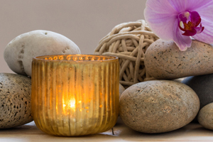 small stones, flowers and candles grouped together