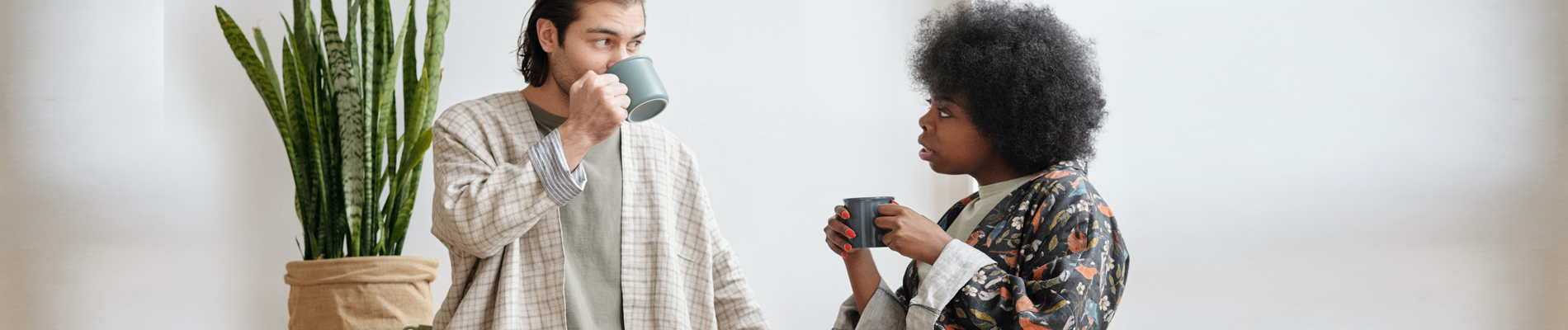 A woman and man with coffee having a discussion