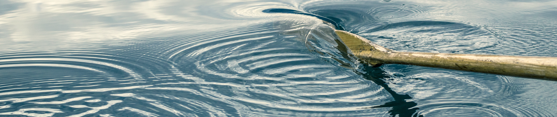 a boat ore moving in the water making swirls