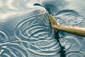 a boat ore moving in the water making swirls