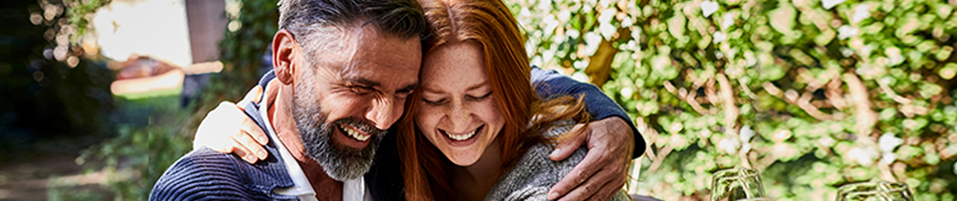 Couple holding each other laughing