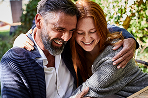 Couple holding each other laughing