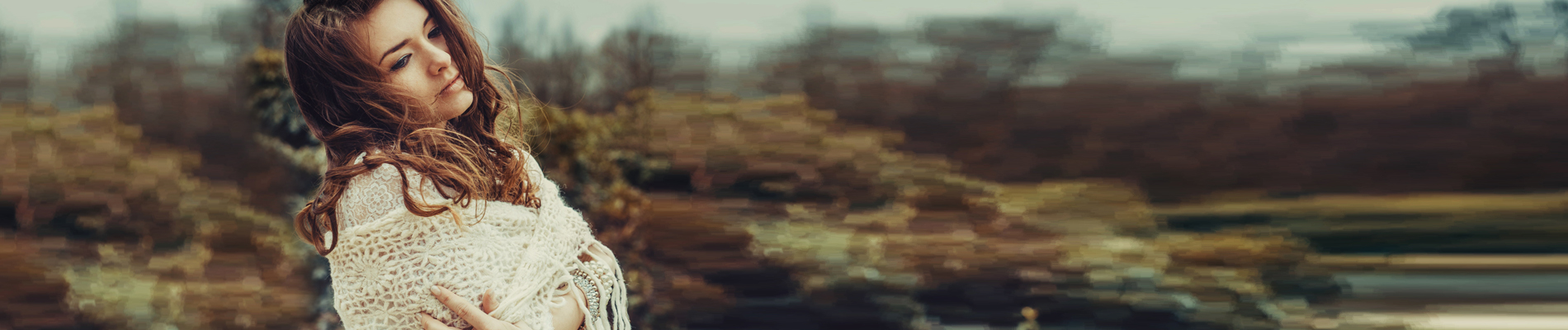 Young woman in a Scholl with arms crossed in an nature setting