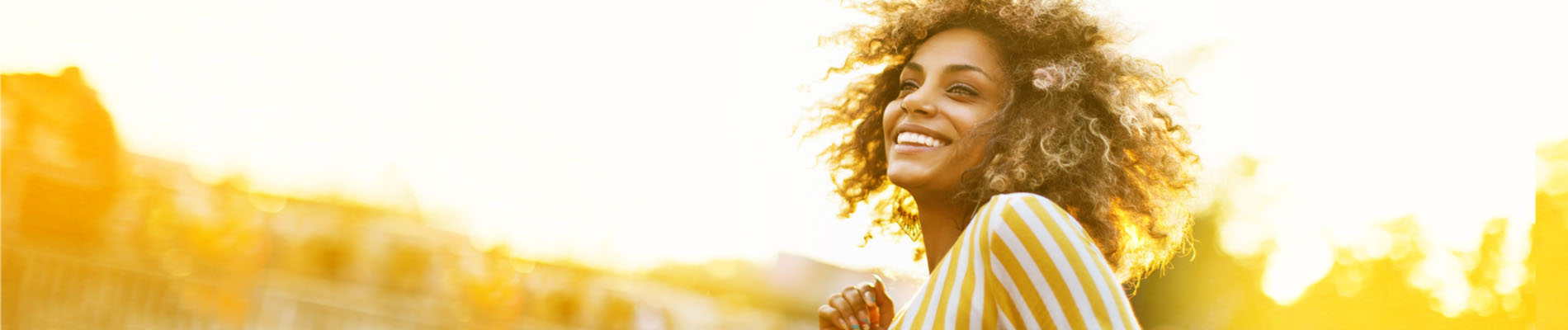 smiling woman outside in a town scene