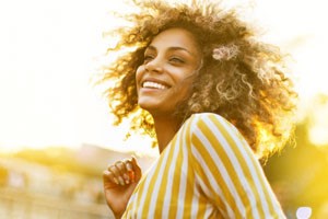 smiling woman outside in a town scene