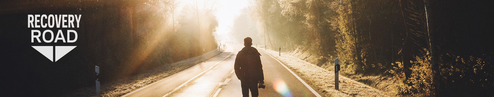 man standing on road