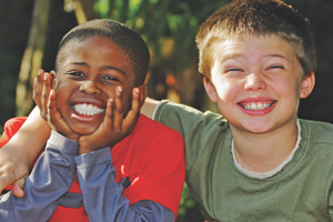 Two young kids smiling at camera